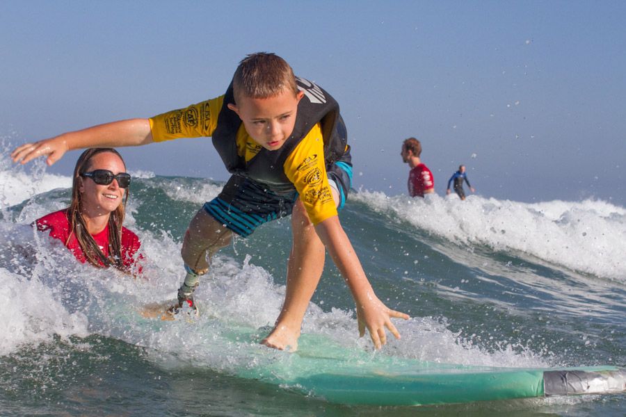 8-year-old surfer, William Thompson, enjoying the waves at La Jolla Shores during the ISA Adaptvie Surfing Clinic. Photo: ISA