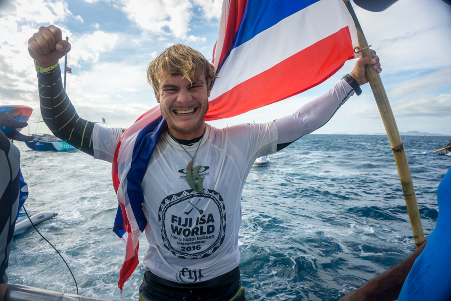 After a day of epic Cloudbreak, Zane Schweitzer holds his flag high as World Champion. Photo: ISA / Sean Evans
