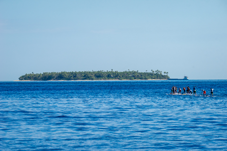 The Men’s SUP Paddleboard Distance Race takes off towards the second buoy at Tavarua. Photo: ISA / Sean Evans