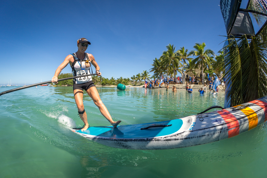 USA’s Candice Appleby triumphantly arrives at Musket Cove to claims her second consecutive Gold Medal in the Women’s SUP Distance Race. Photo: ISA / Sean Evans