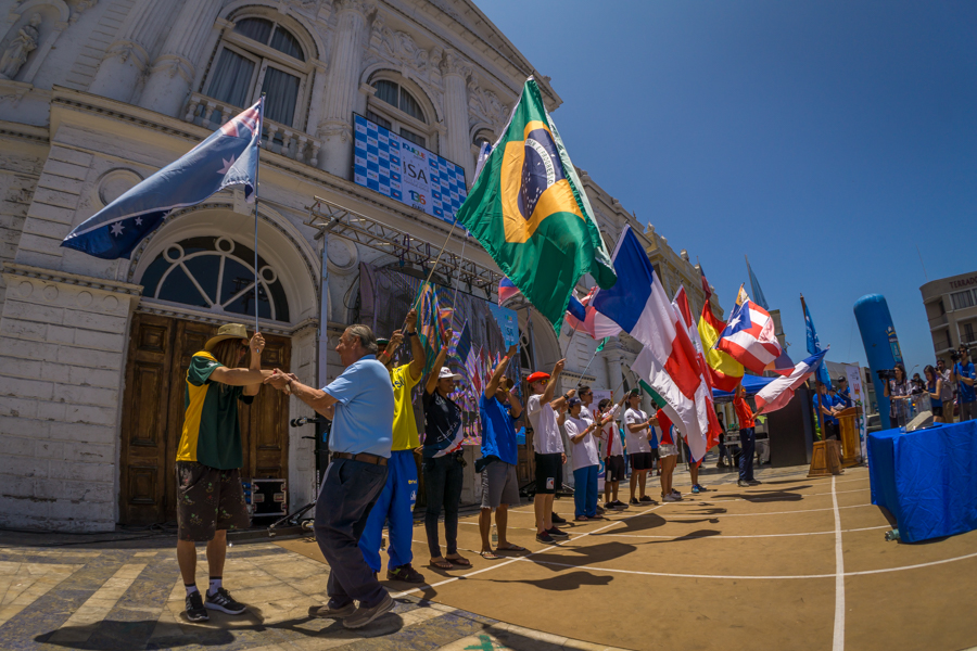 A representative from each National Delegation takes to the stage waving their flags. Photo: ISA/Sean Evan