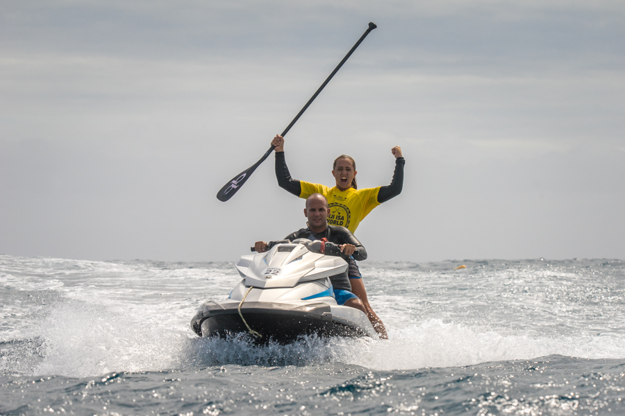 Australia’s Shakira Westdorp returns to the channel to celebrate her victory with her team. Photo: ISA / Sean Evans