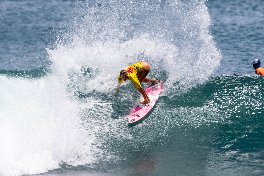 Chelsea Teauch from Barbados throws spray and before advancing to Round 2 of the Main Event. Photo: ISA/Dave Nelson
